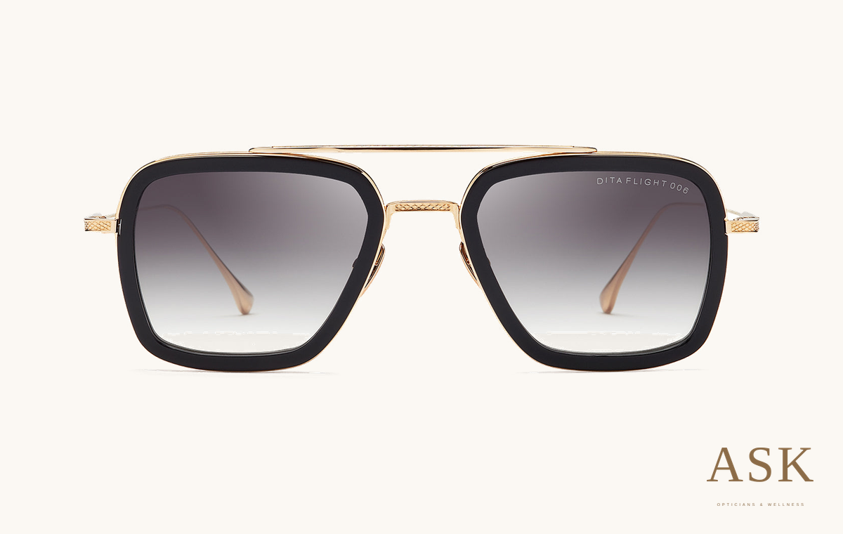DITA Flight 006, Matte Black - 14K Gold / Grey to Clear Gradient, front view on ivory with the ASK logo