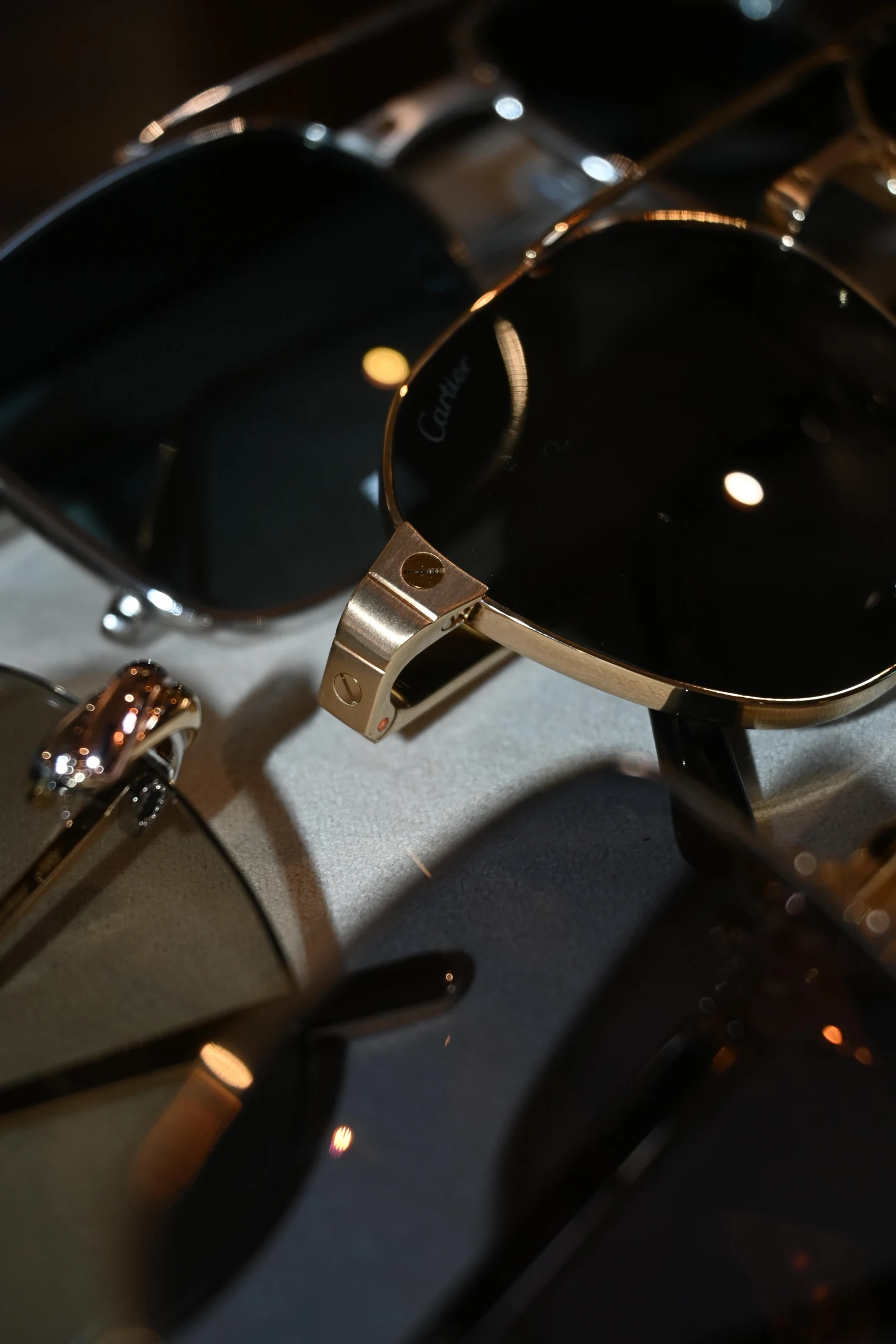 Dark Cartier lenses and polished gold-tone frame details, photographed at ASK Opticians