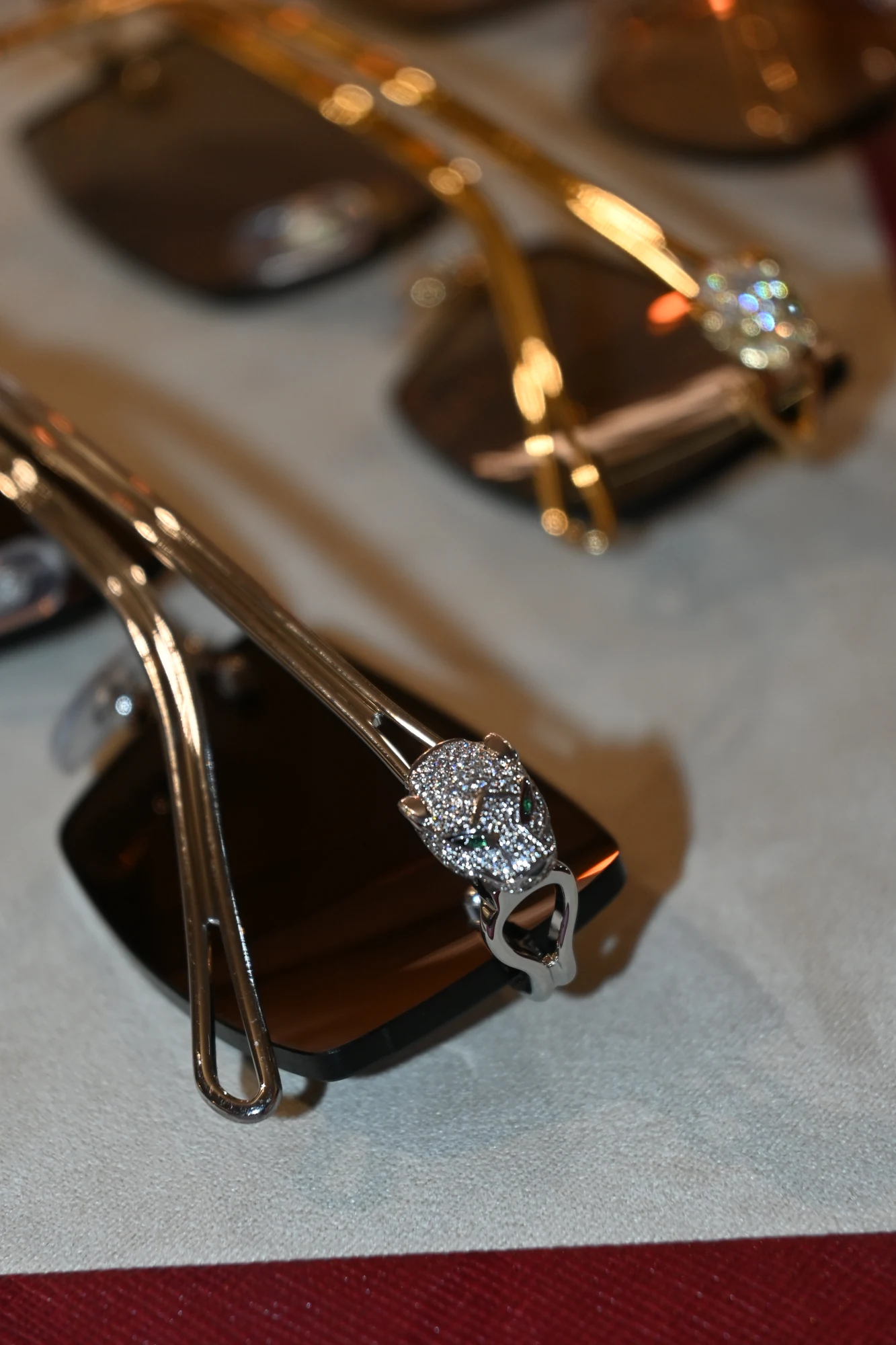 Cartier Precious Panthère with a diamond-set panther detail and brown lenses, photographed in ASK's eyewear tray