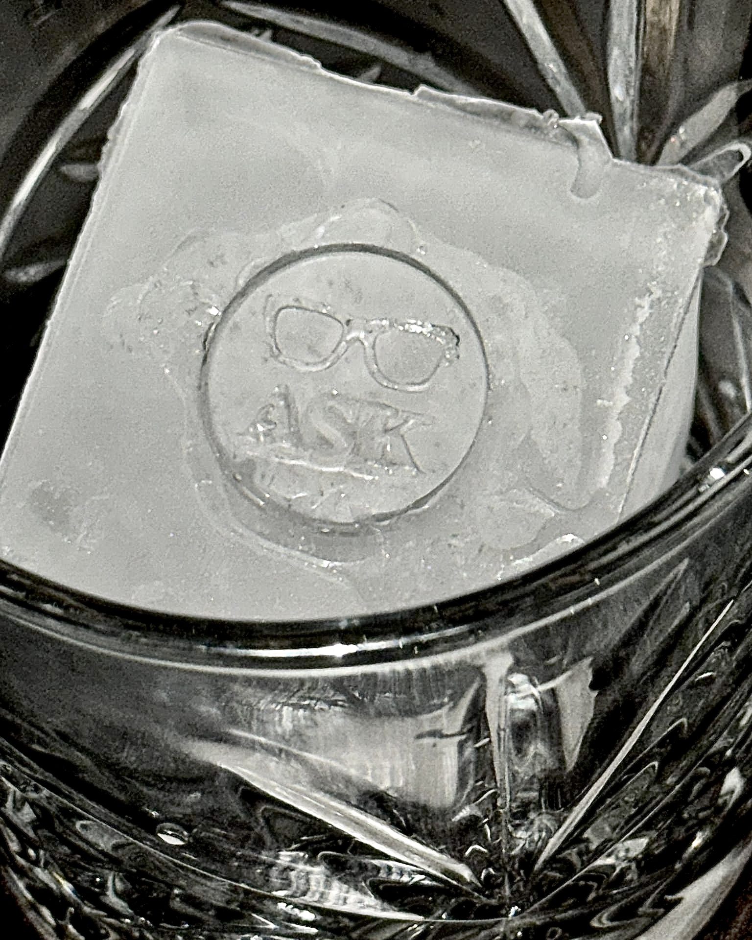 An ice cube stamped with the ASK logo