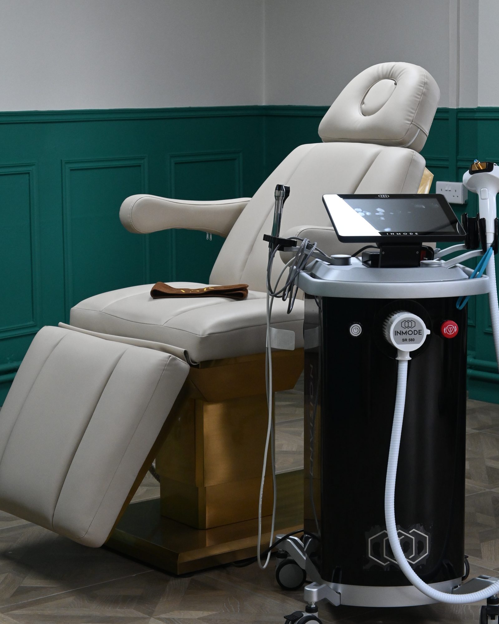The treatment room at ASK Wellness, with the InMode Envision beside the treatment bed