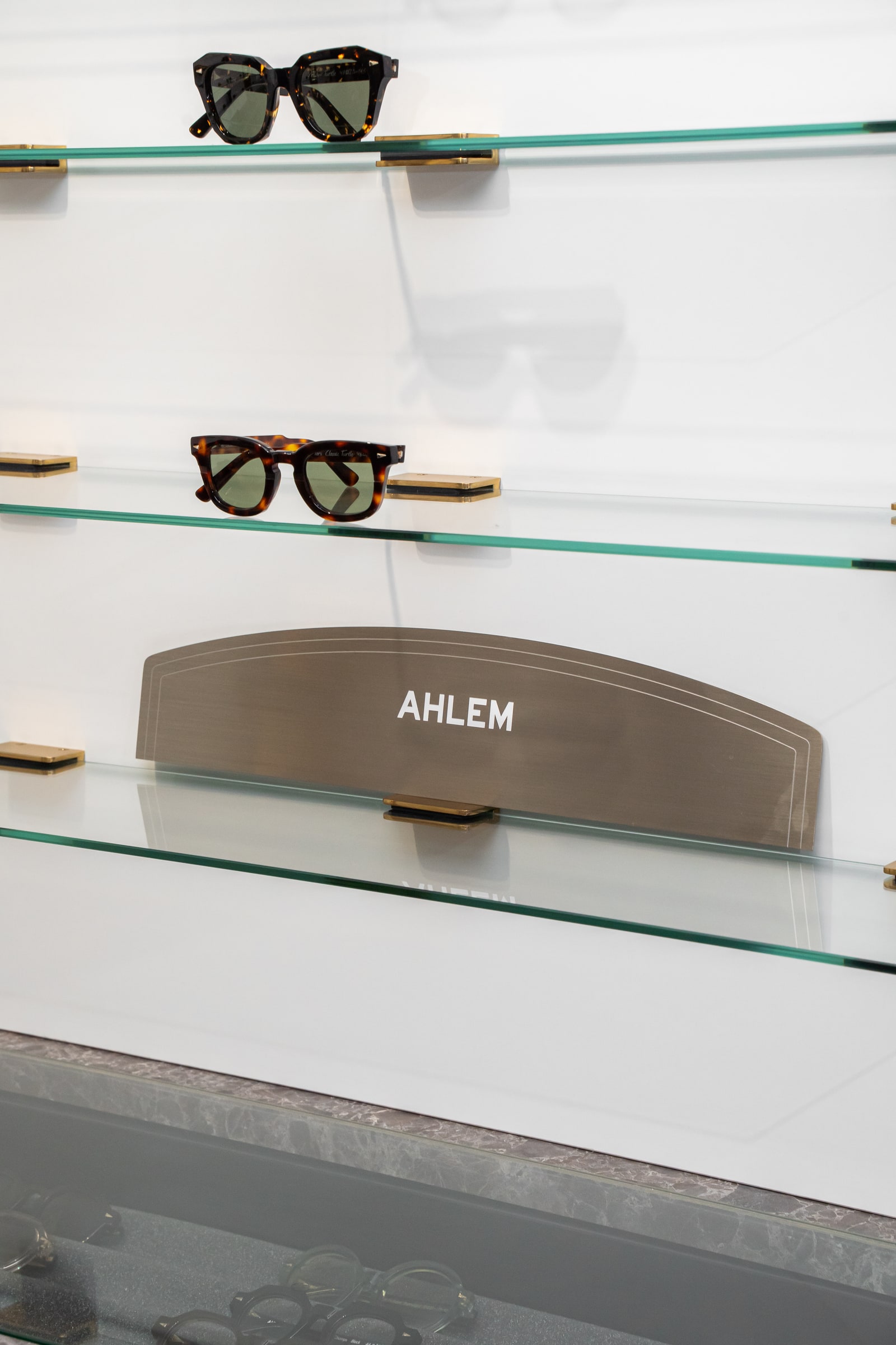 AHLEM eyewear on the illuminated glass shelves at ASK