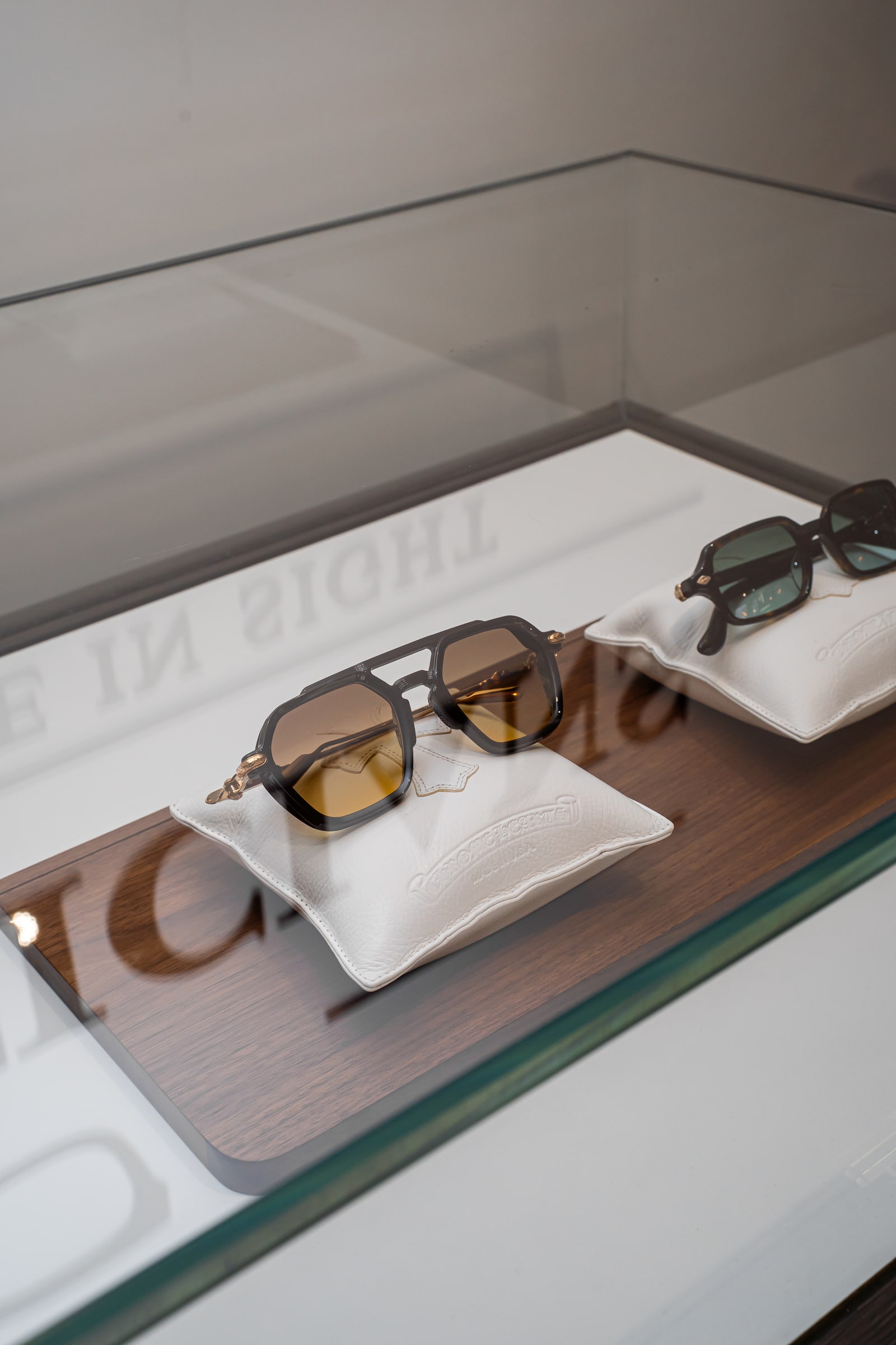 An amber-tinted frame displayed on a white cushion inside the ASK cabinet