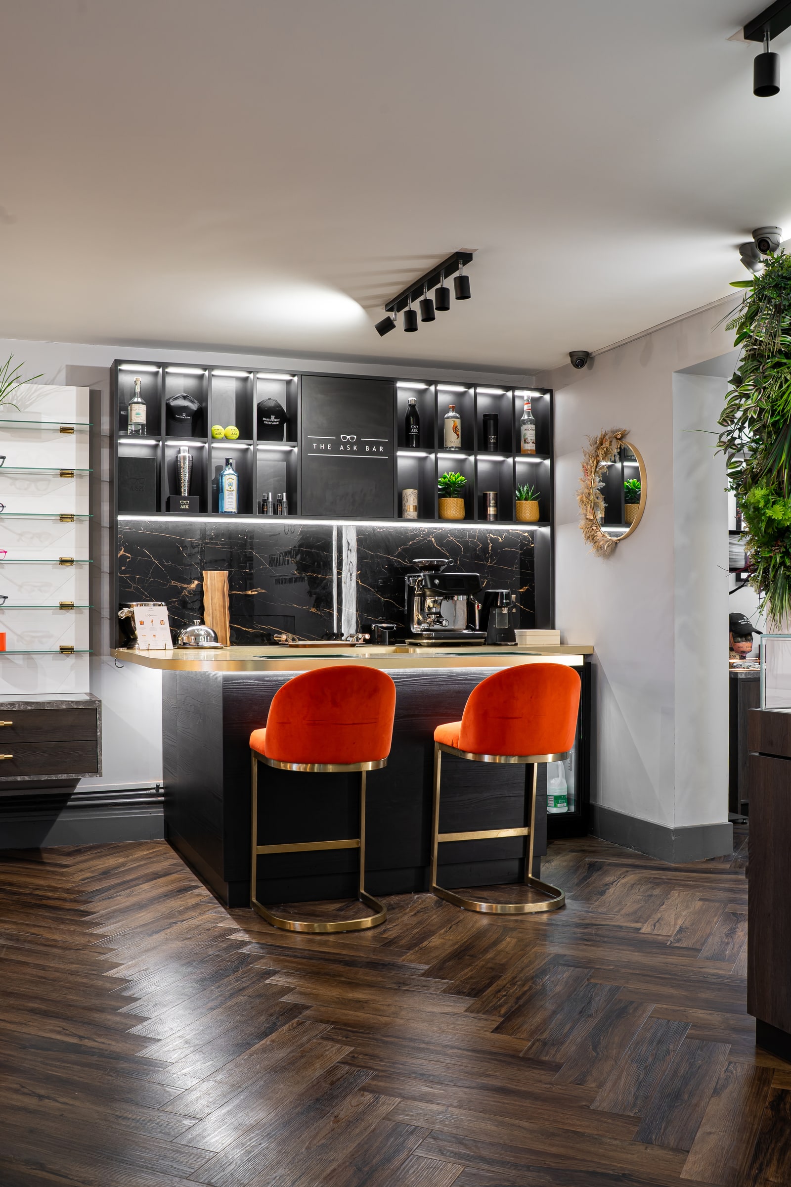 The ASK Bar with red velvet seats and illuminated shelves