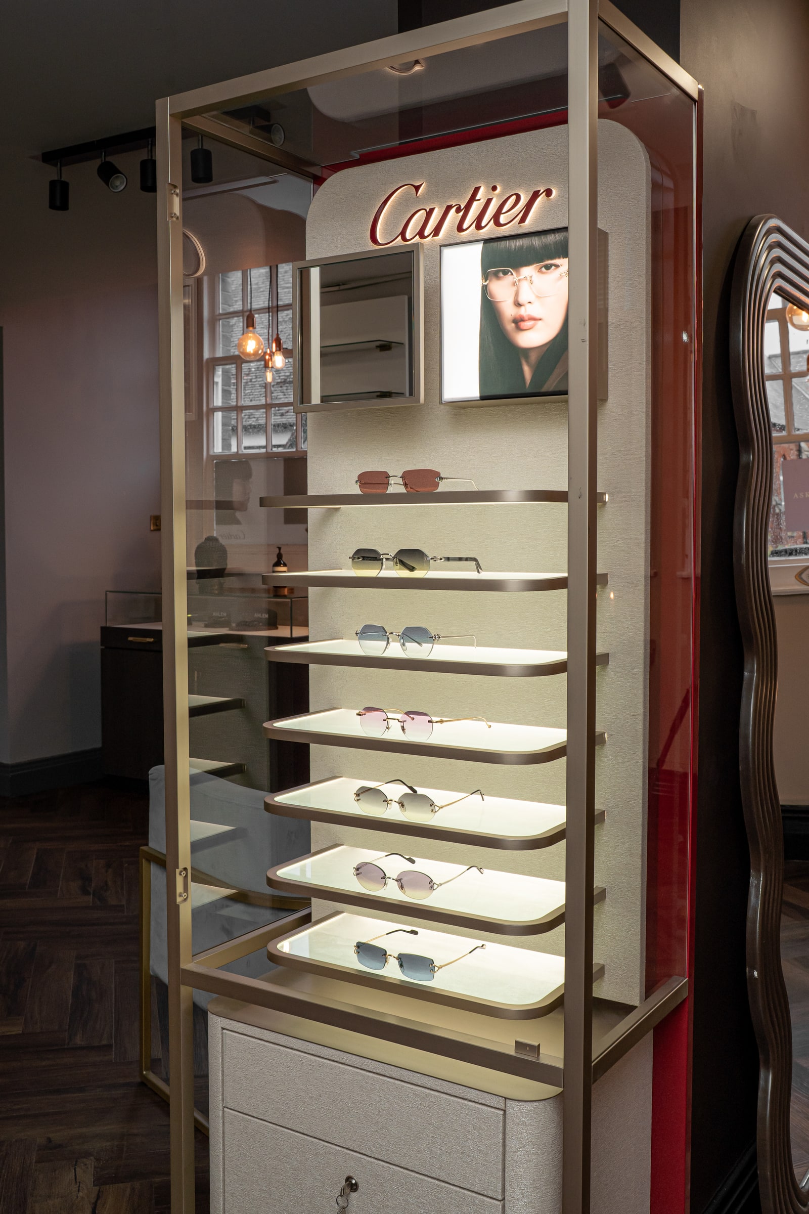Cartier eyewear displayed in the illuminated Cartier cabinet at ASK