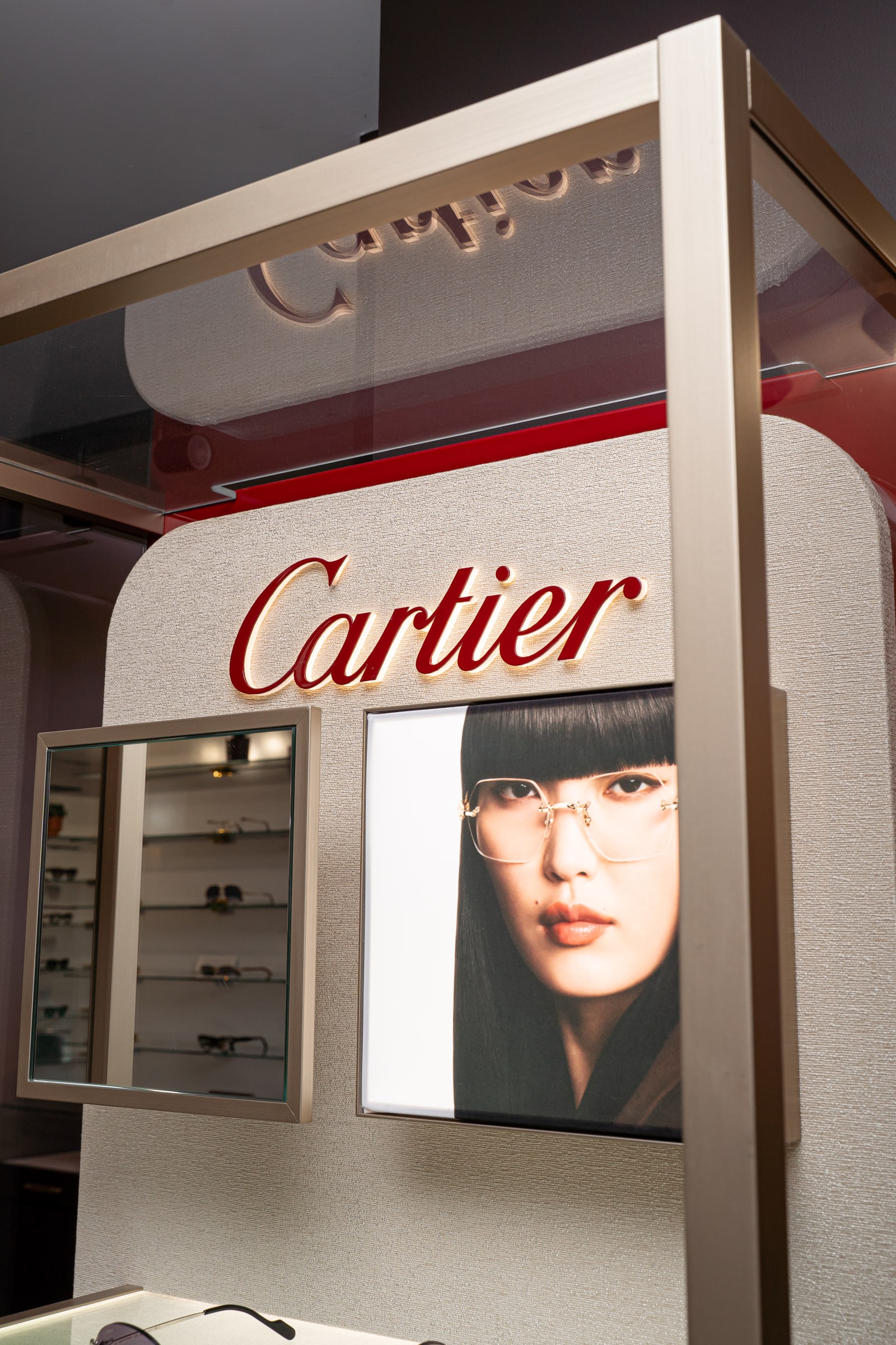 The Cartier sign and display above the eyewear shelves at ASK