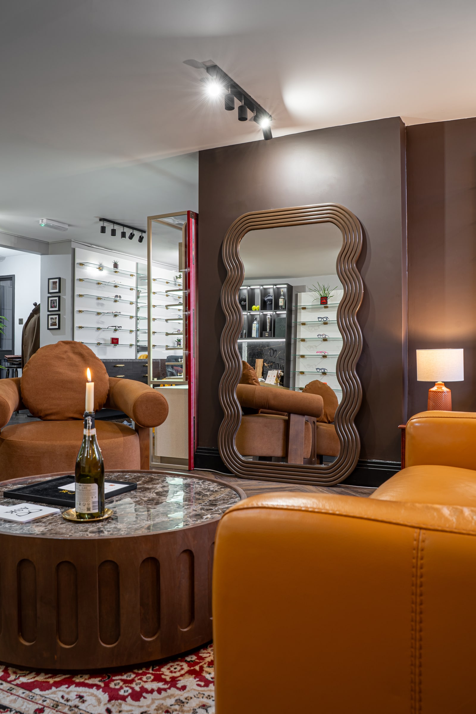 Brown lounge seating, marble tables and the sculpted mirror at ASK