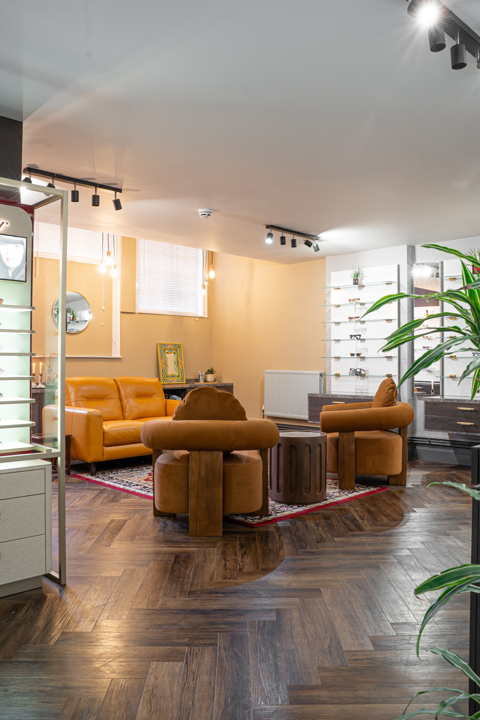 Sunlight across the brown lounge seating and patterned rug at ASK
