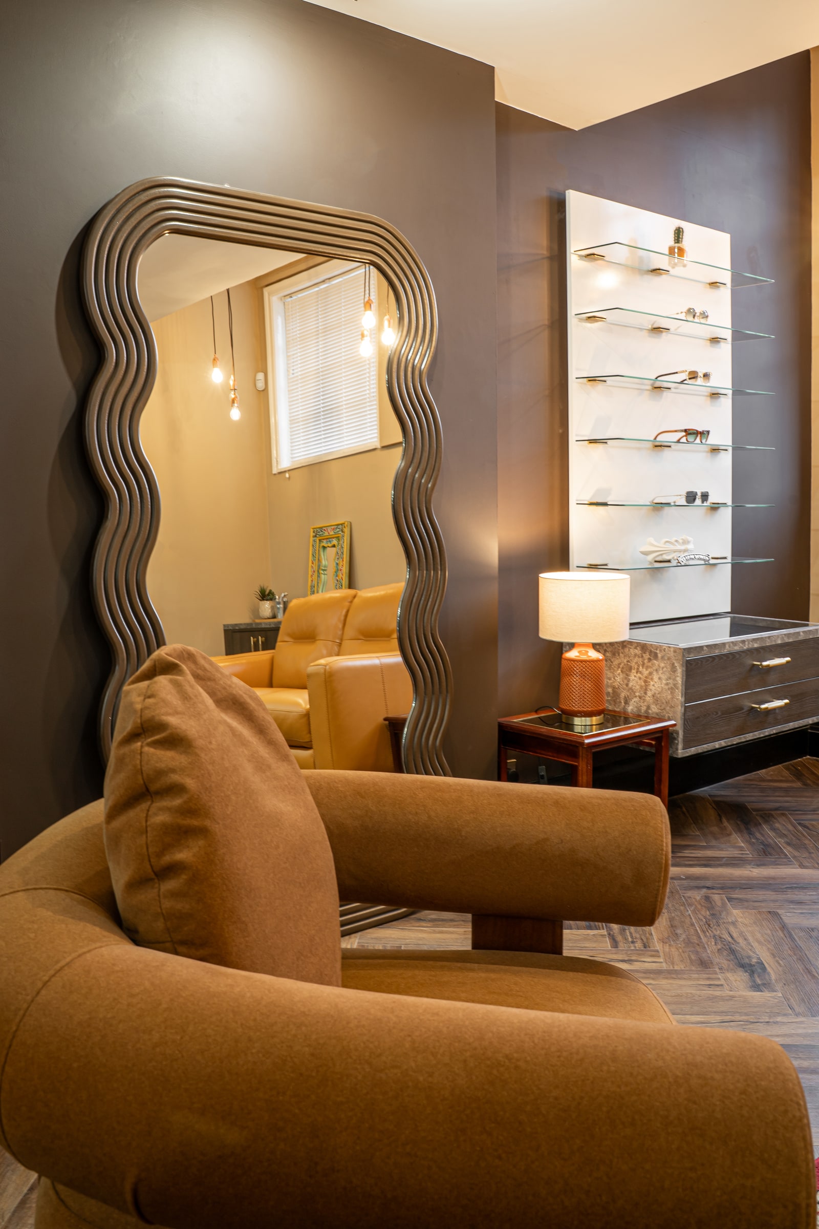 The sculpted mirror and lounge seating at ASK Opticians