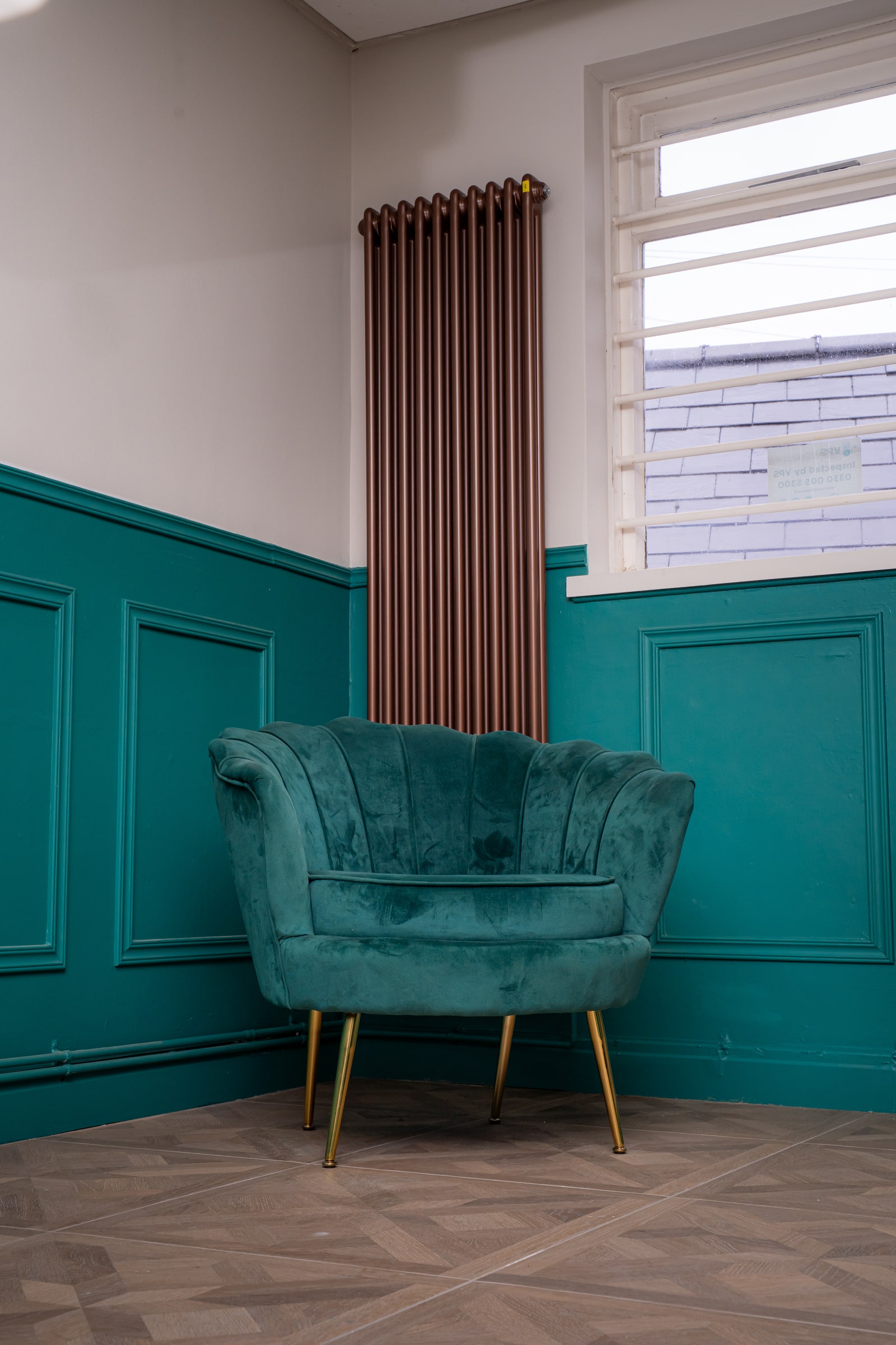 A green velvet chair in a quiet corner of the clinical room
