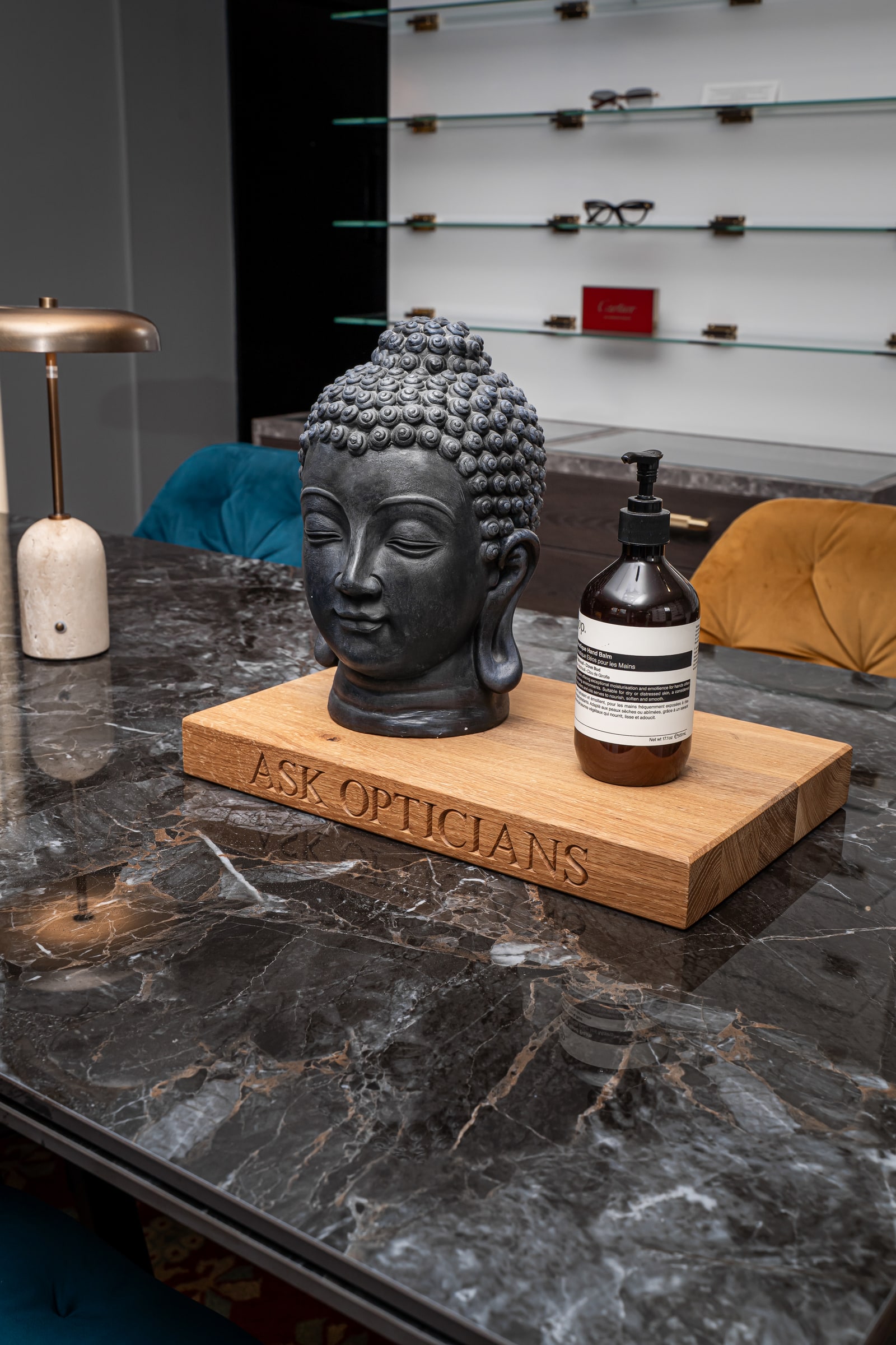 The ASK Opticians wooden sign and ornaments on the eyewear styling table