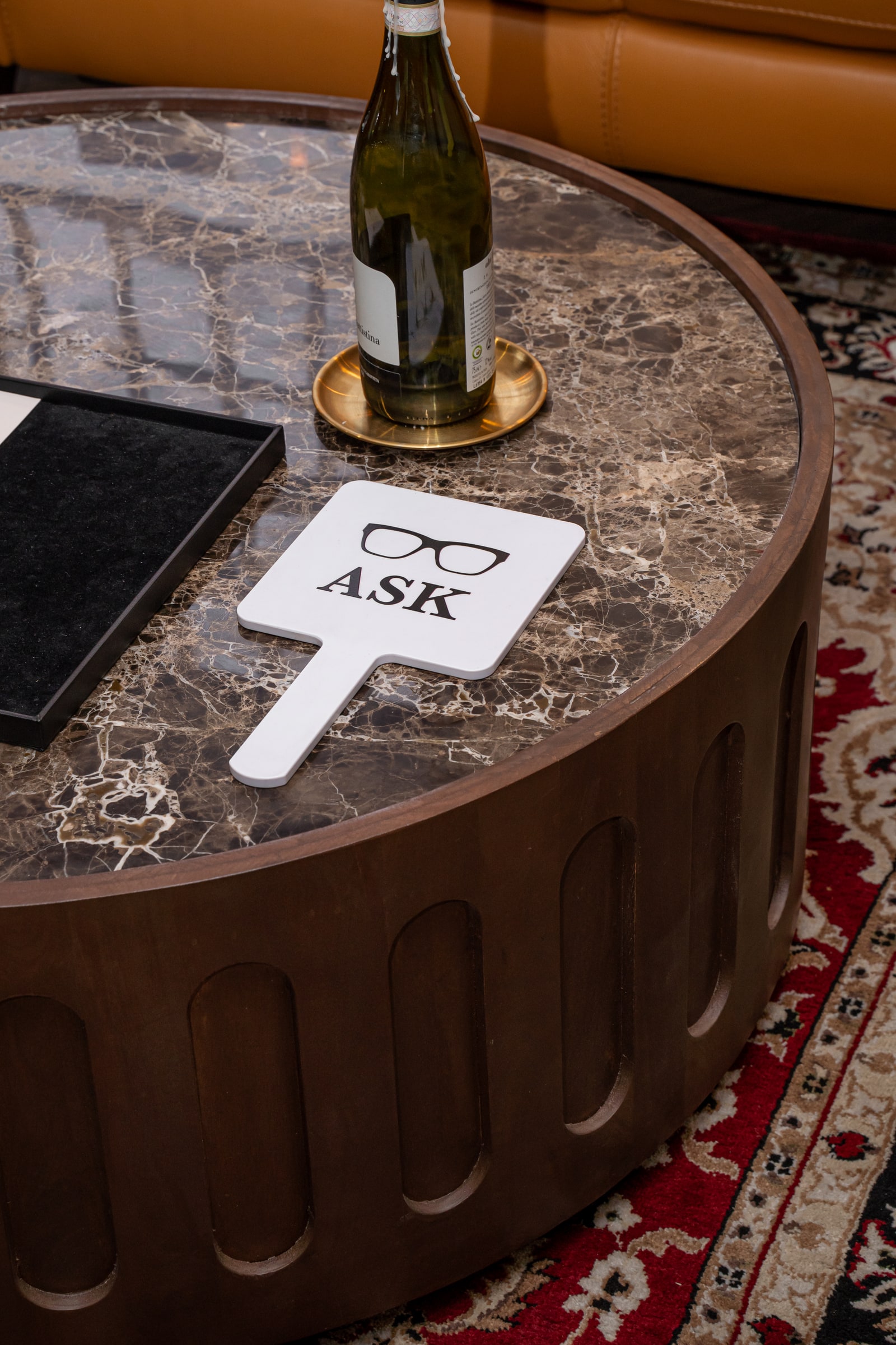The ASK hand mirror and presentation tray on a marble lounge table