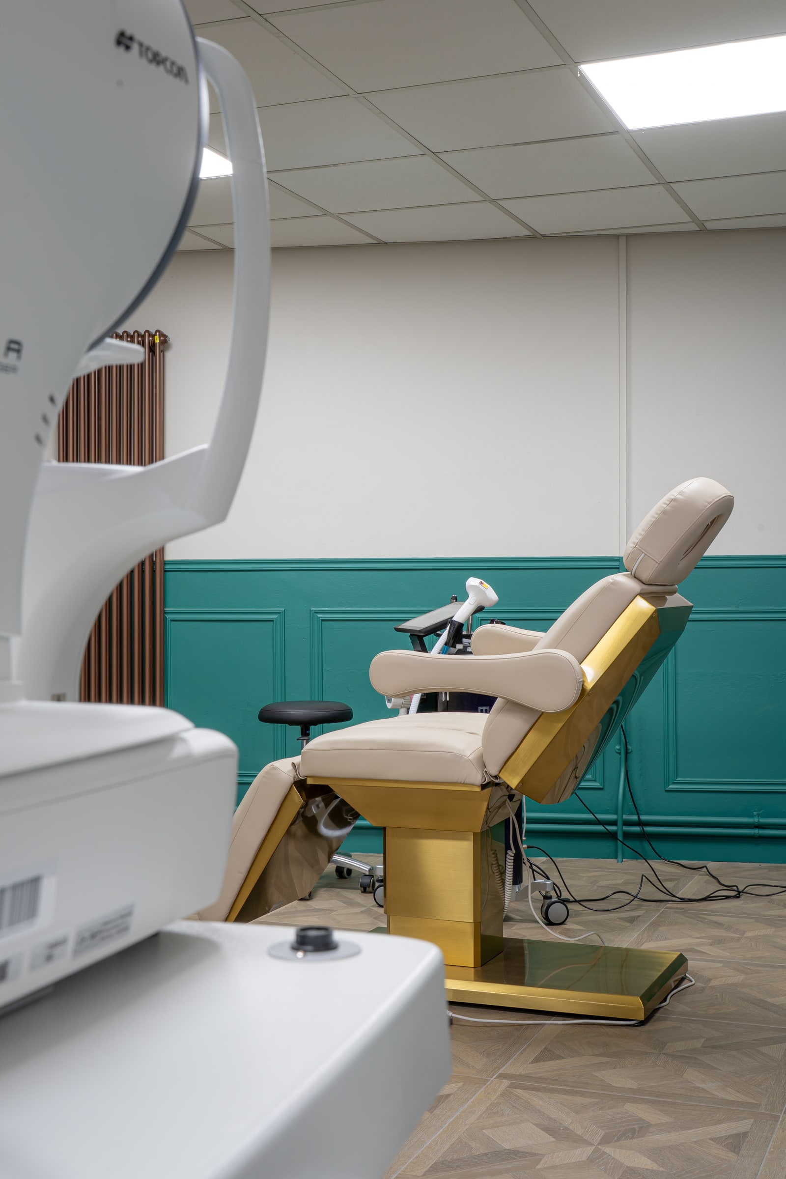 The cream wellness treatment chair seen from beside the clinical equipment
