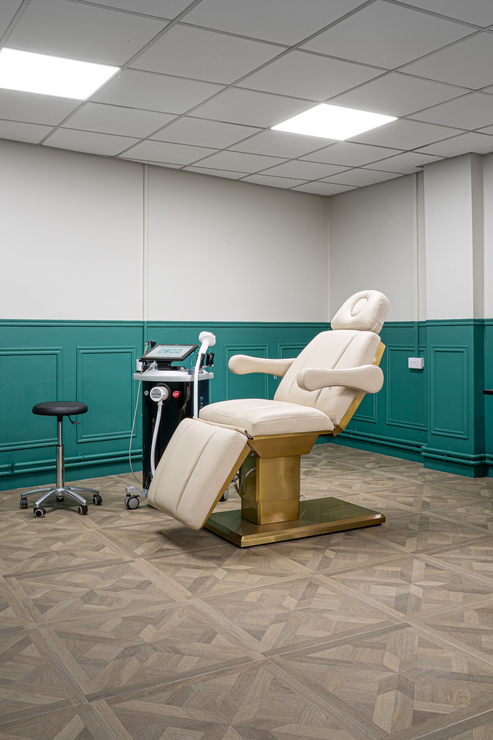 A wide view of the wellness room with its treatment chair and equipment
